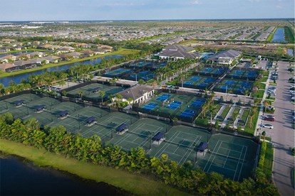  Aerial view of the GL Homes Riverland sports complex in Port St. Lucie, featuring pickleball, tennis, and bocce courts designed to promote active, healthy living.
